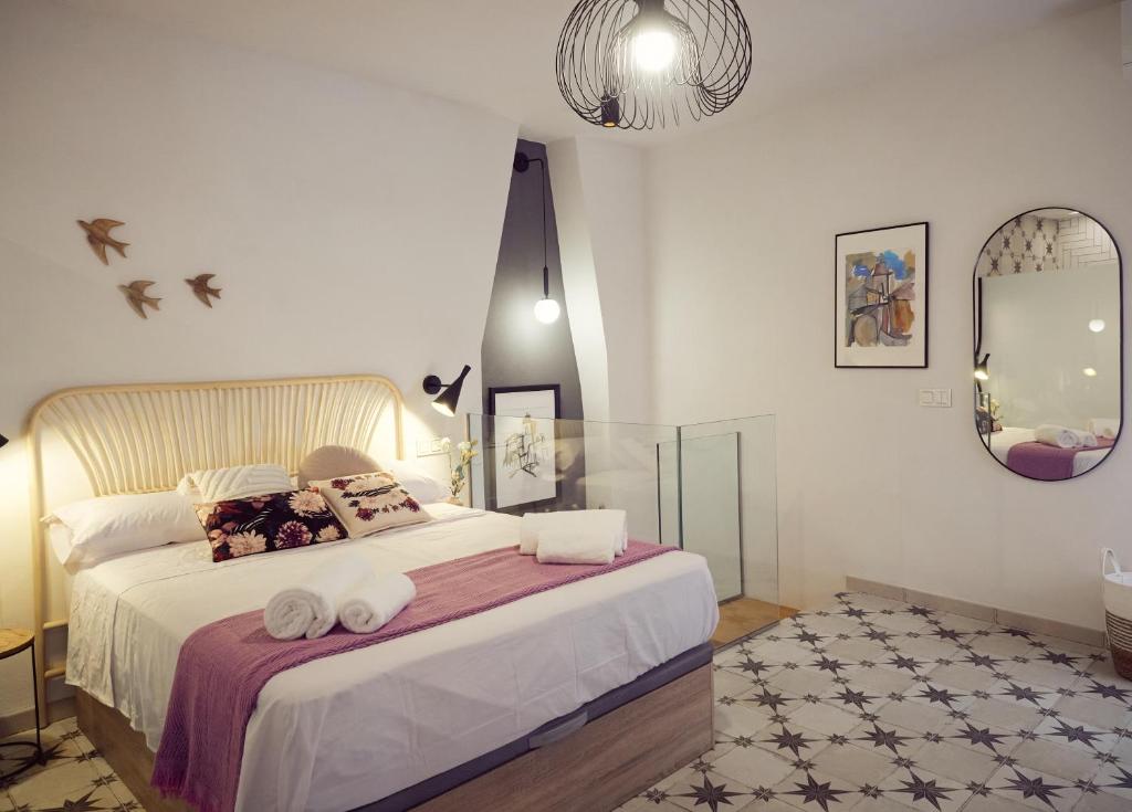 a bedroom with a bed with two towels on it at La Encantada in Elche de la Sierra