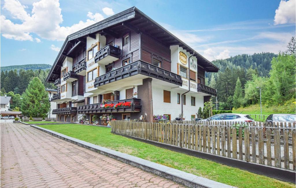 a large building with a fence in front of it at Amazing Apartment In Racines-ratschings With Wifi And 2 Bedrooms in Stanghe