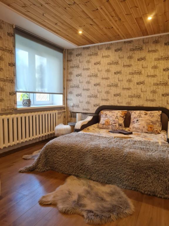 een slaapkamer met een groot bed en een raam bij Hannah in Krāslava