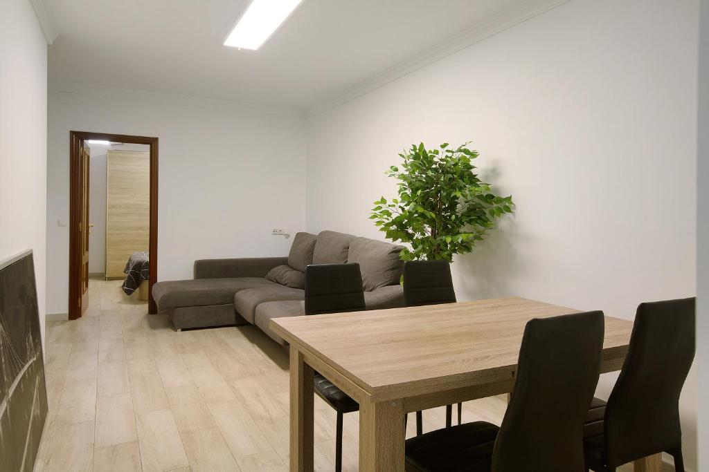 a living room with a table and a couch at Apartamento Casa Italia in Vecindario