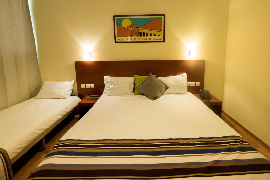 Postel nebo postele na pokoji v ubytování Villa Nazareth B&B