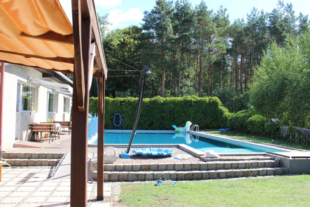a swimming pool with a slide in a yard at Gospodarstwo Agroturystyczne Agroletnica in Świdnica