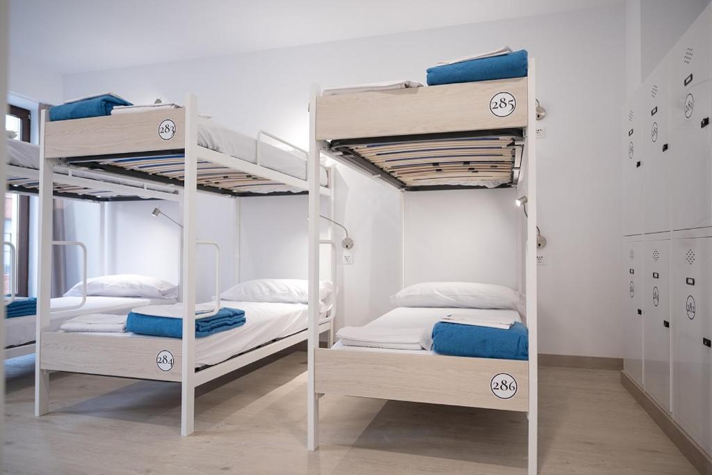 a room with two bunk beds in a room at PALACIO REAL HOSTEL in León