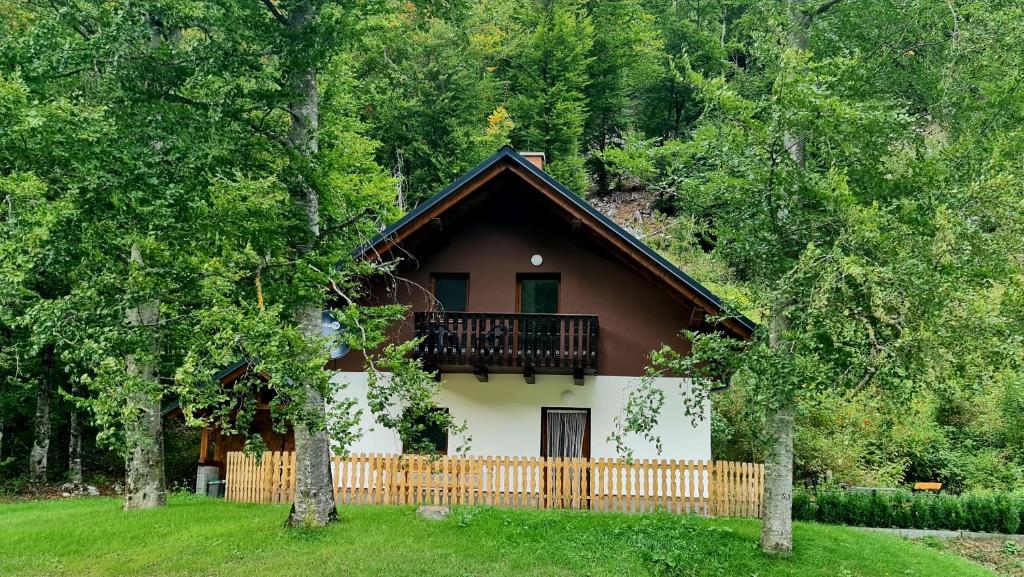 a house with a balcony on top of it at Radovna Mountain Valley Cottage in Zgornje Gorje