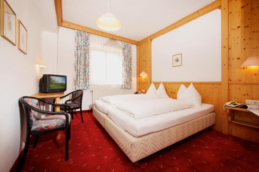 Postel nebo postele na pokoji v ubytování Hotel Grafenwirt
