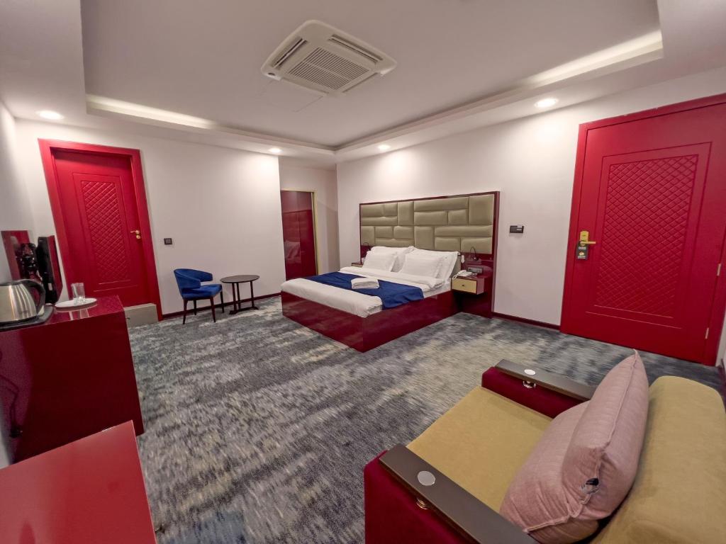 a hotel room with two beds and red doors at Denis hotel in Tbilisi City