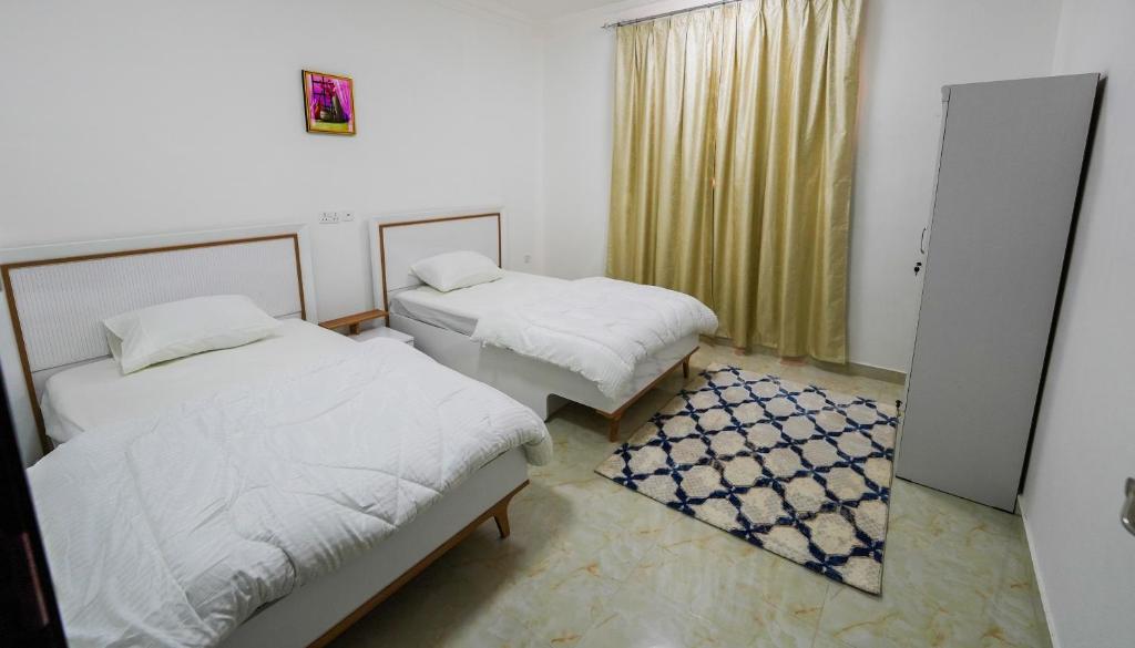 Postel nebo postele na pokoji v ubytování نسائم صلاله للشقق الفاخرة Nassayem Salalah Downtown