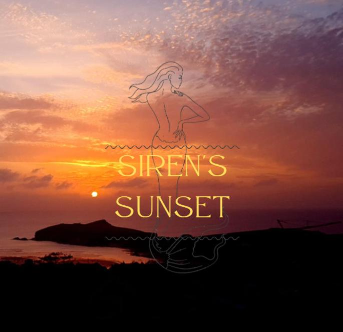 a sunset with a girl standing in the water at Sirens Sunset Peaceful Retreat with stunning sea views, 5 minutes from Porth Beach in Newquay