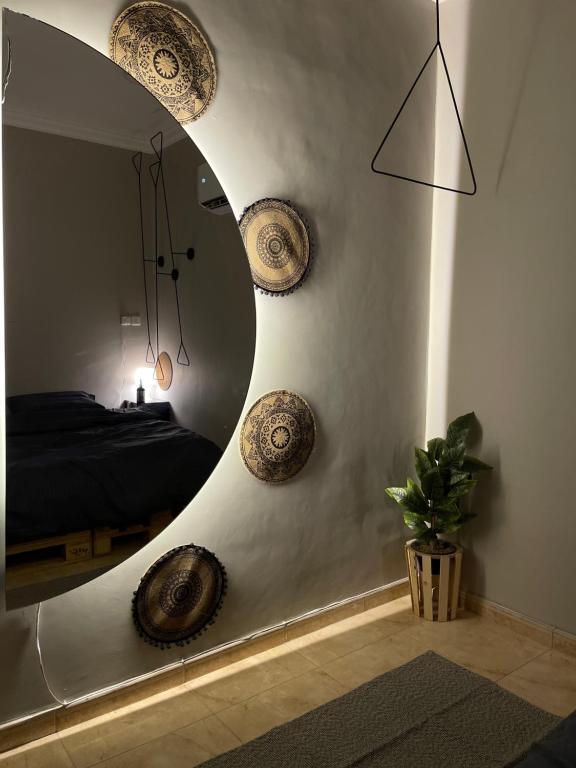 a bedroom with a large circular mirror in a room at Entire apartment in Al Ahsa