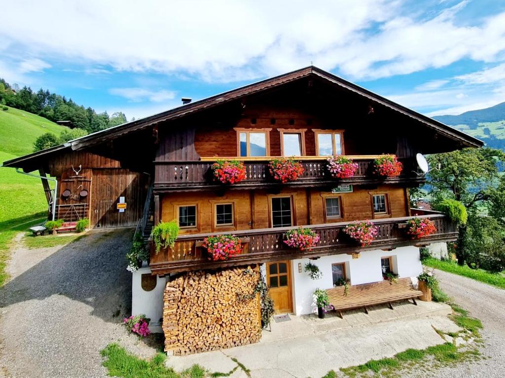 a wooden house with a bench in front of it at Ferienwohnung Staudach, Apartment in Fügenberg