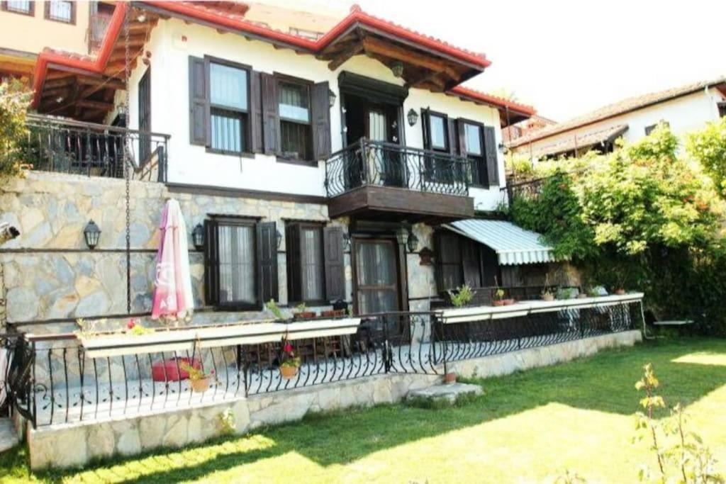 a house with a fence in front of it at Escape to History in a Stunning Stone House with Garden and Sea View in the Heart of Alanya in Alanya