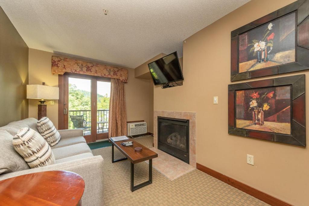 a living room with a couch and a fireplace at A207 One Bedroom Lake View in Oakland