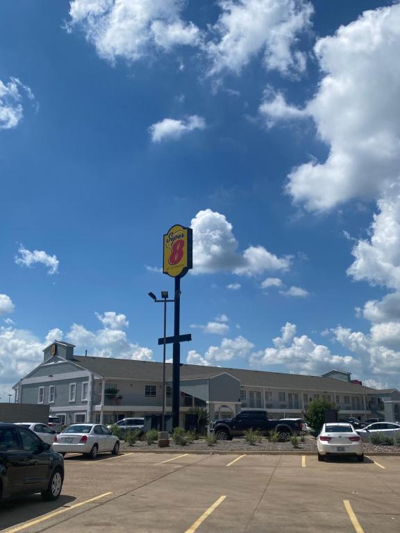 a parking lot with a traffic light in front of a building at Super 8 by Wyndham Terrell in Terrell