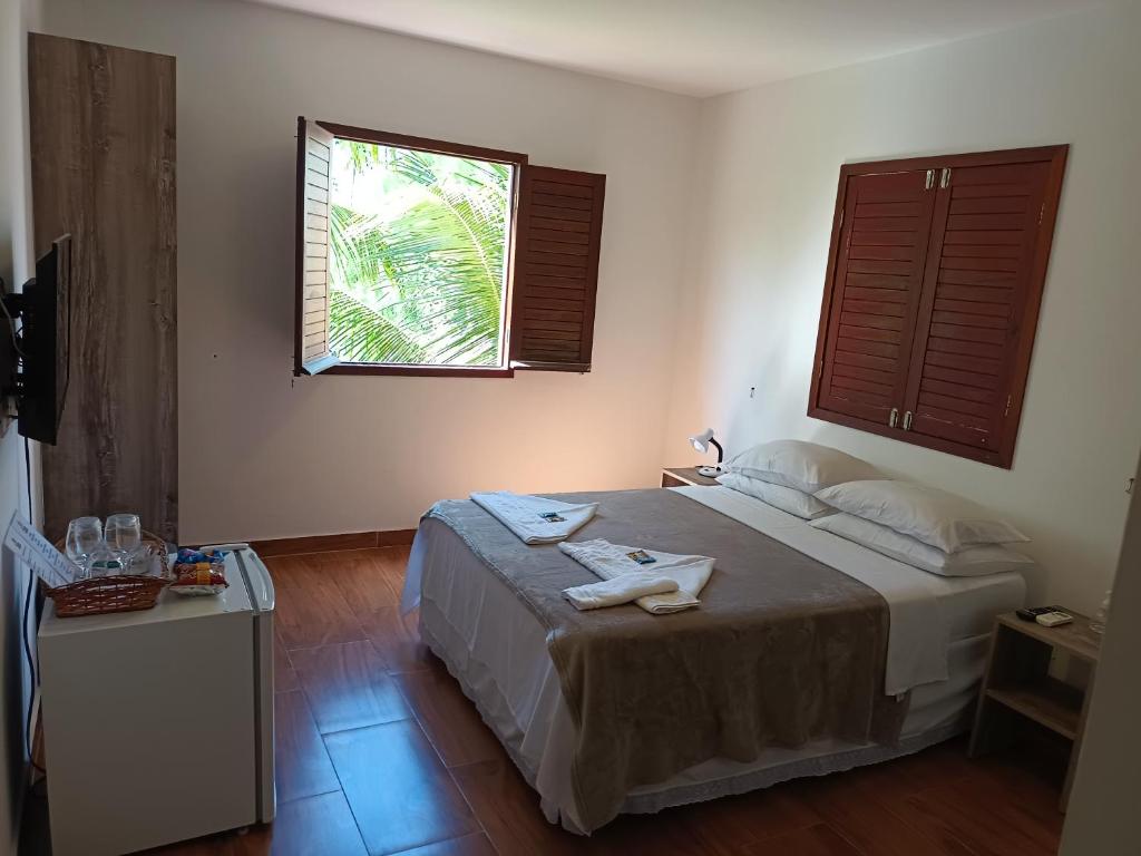 Postel nebo postele na pokoji v ubytování Pousada Vila dos Santos