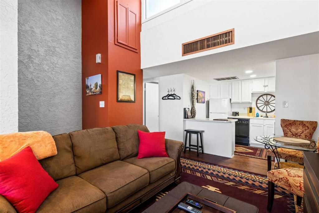 a living room with a couch and a kitchen at Nightlife & Shop Old Town Scottsdale - Studio Unit in Scottsdale