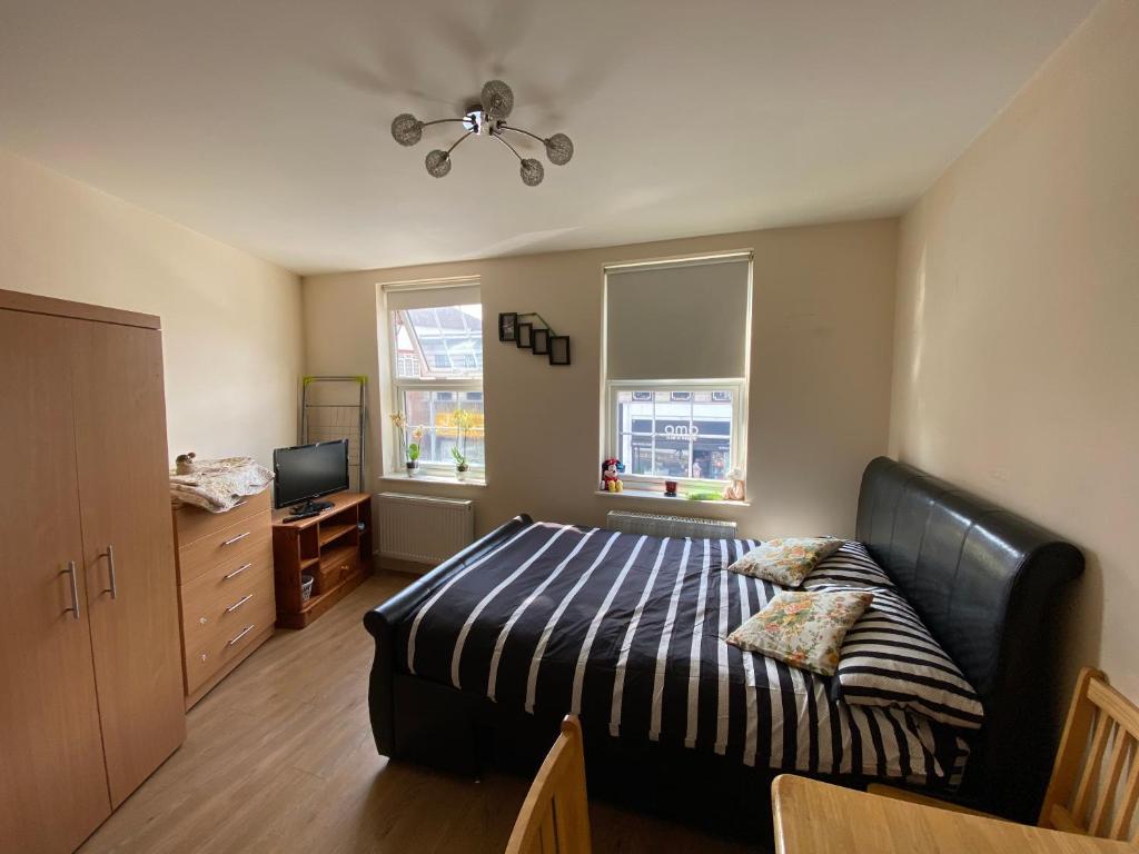 a bedroom with a bed and a television in it at Stefi apartment room in Edgware