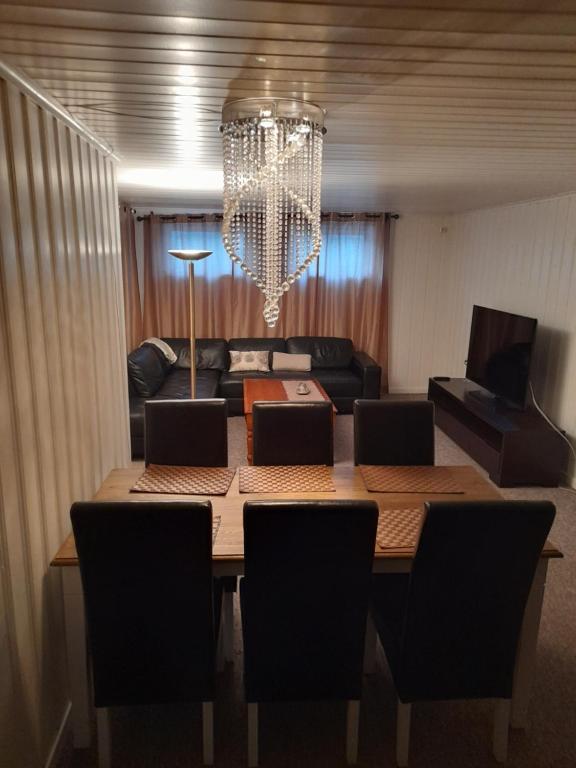 a dining room with a table and a couch at apartment on the first floor of the house in Skien