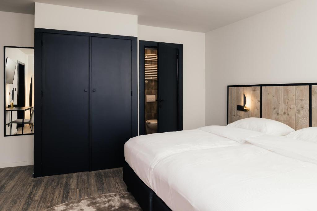 Postel nebo postele na pokoji v ubytování Hotel Au lit des ours
