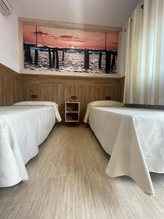Łóżko lub łóżka w pokoju w obiekcie Hostal Noli