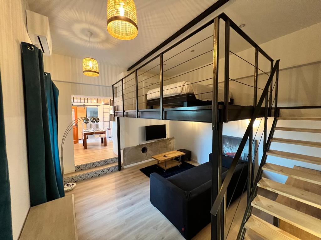 a living room with a staircase and a bunk bed at Mas Thomasine Séjour Romantique au calme in Peillon