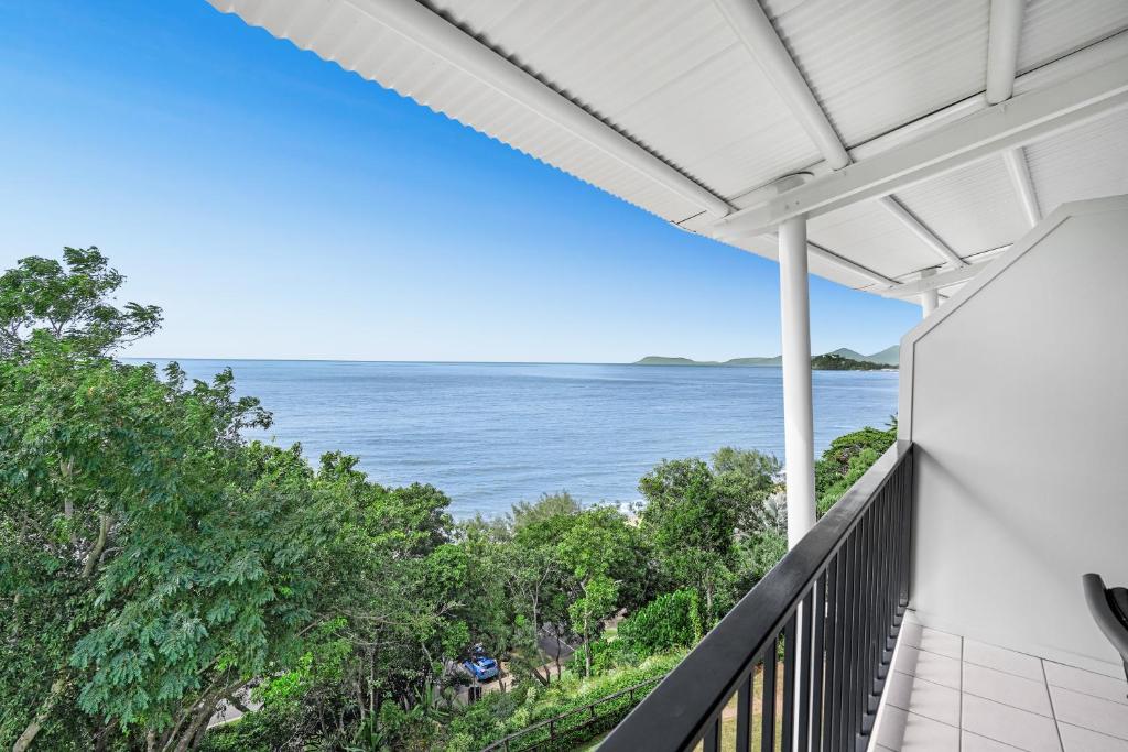 a view of the ocean from the balcony of a house at Amaroo At Trinity in Trinity Beach