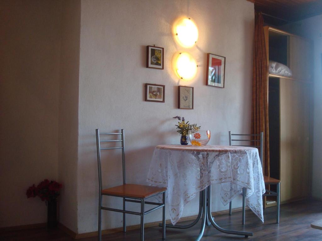 a table with two chairs and a white tablecloth on it at Apartment Krk 11646a in Krk