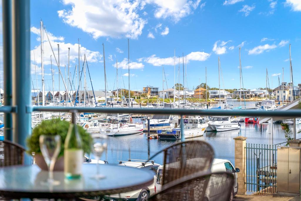 a view of a marina with a table and chairs at All Decked Out, Geographe Marina in Busselton