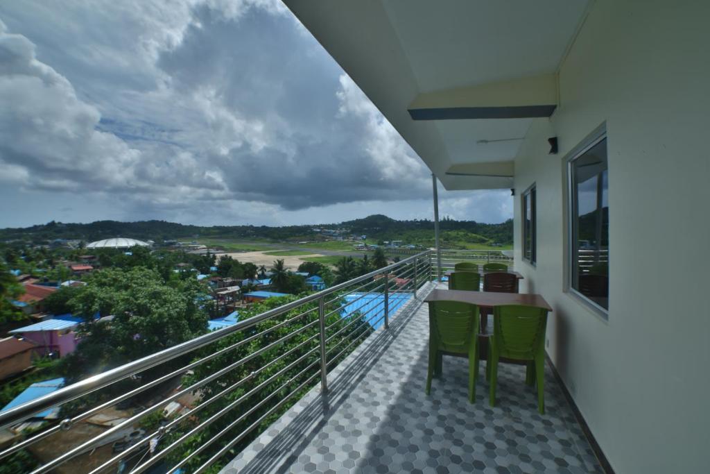 a balcony with a table and chairs and a view at The Lagoon shade in Port Blair