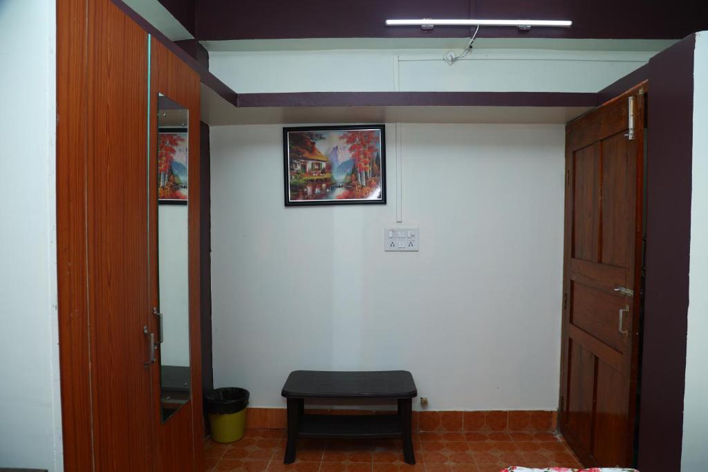 a room with a door and a stool on a wall at The Lagoon shade in Port Blair