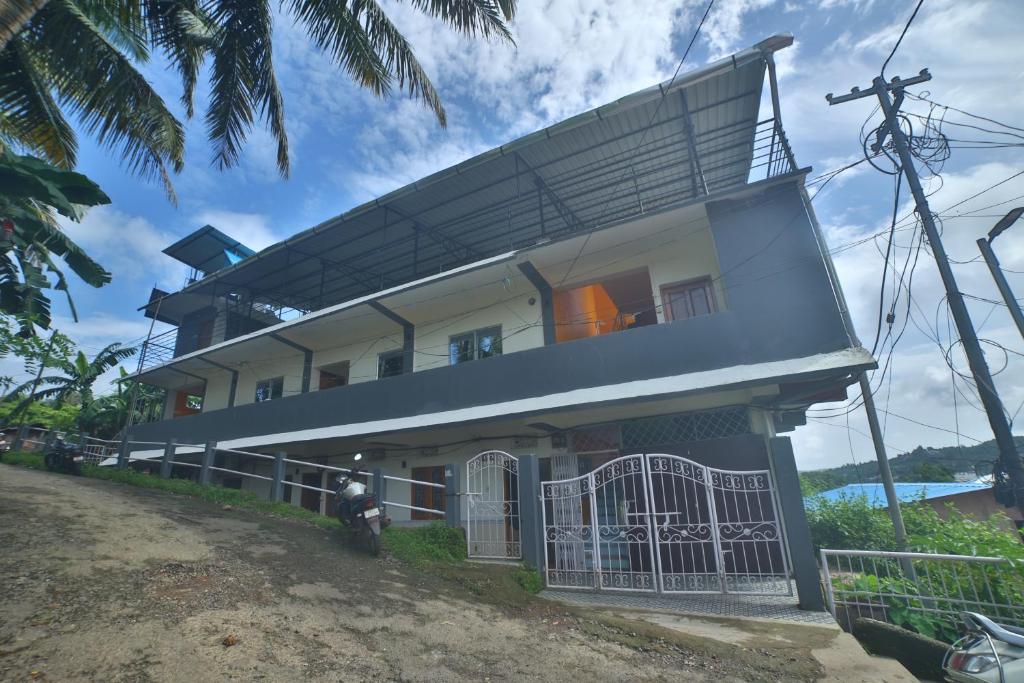 a house with a balcony on top of it at The Lagoon shade in Port Blair