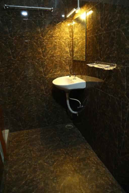 a bathroom with a sink and a mirror at The Lagoon shade in Port Blair