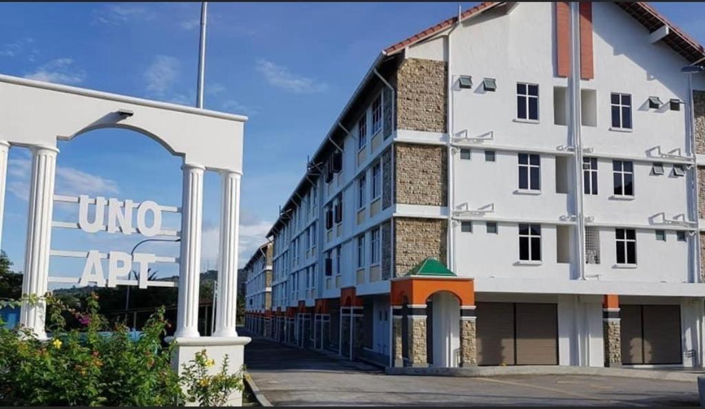 a large white building with an arch in front of it at Homestay Teratak Kasih in Sandakan