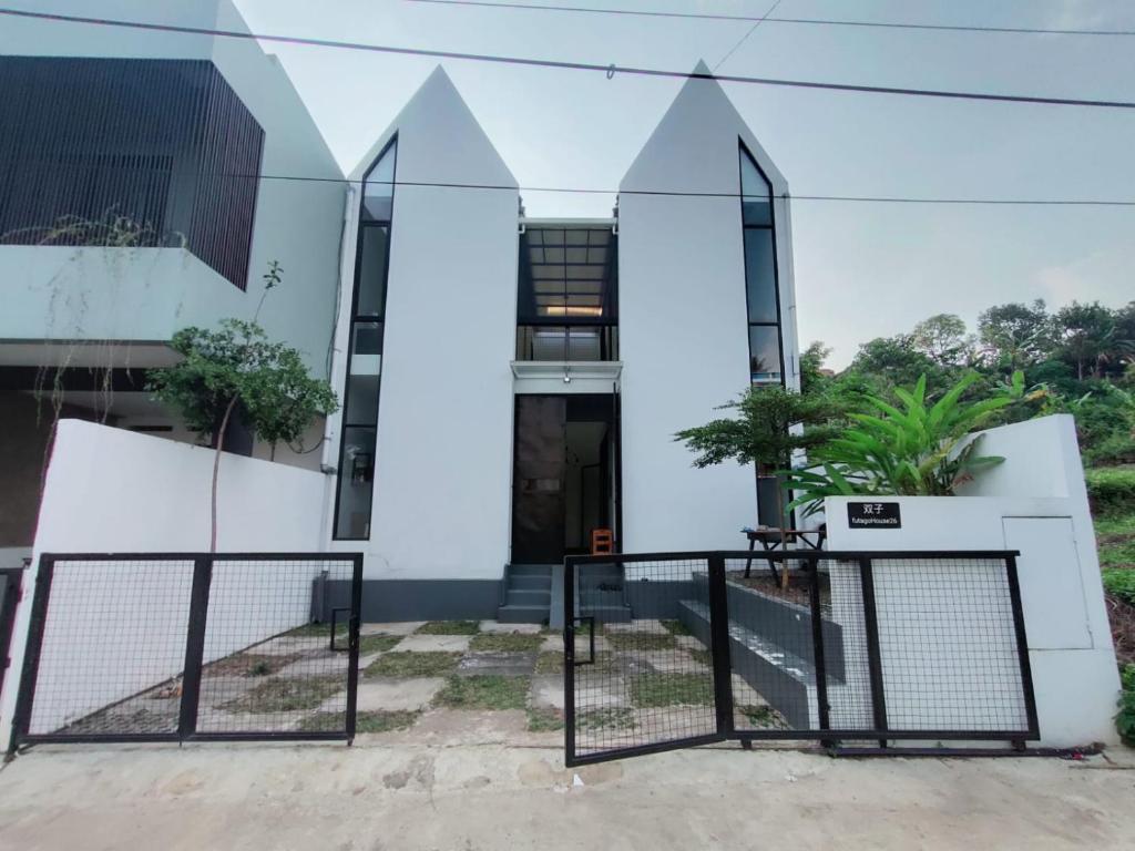 a house with a gate in front of it at Rumah Kembar DI kawasan wisata lembang in Citeureup 1