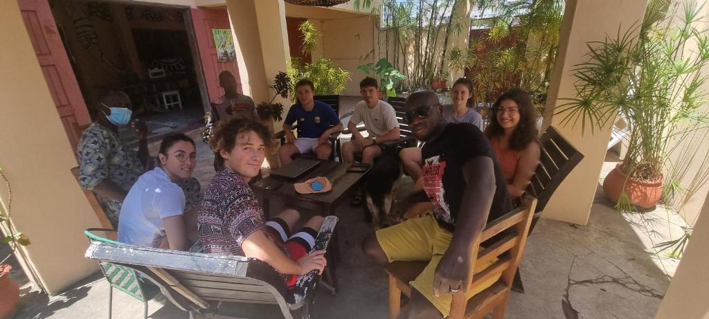 a group of people sitting at tables in a room at La Guesthouse Étoile in Cotonou
