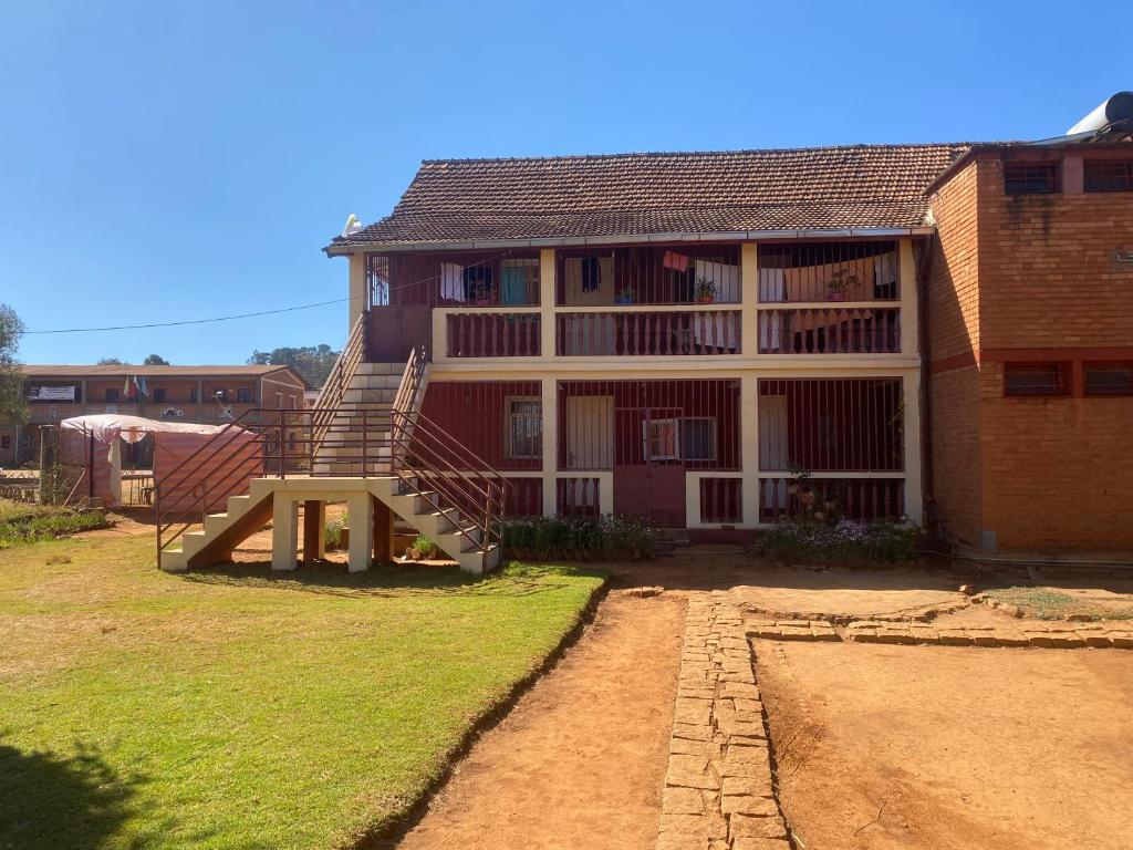 a house with a slide in front of it at Lycée Picot de Clorivière dont les revenus financent l'éducation des élèves in Antsirabe