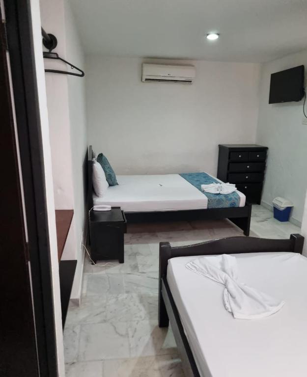 Postel nebo postele na pokoji v ubytování Blue Star Hotel