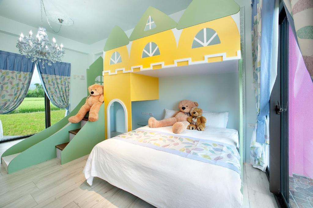 a childs bedroom with a bunk bed with teddy bears at Fairy Story Village Farm B&amp;B in Dongshan