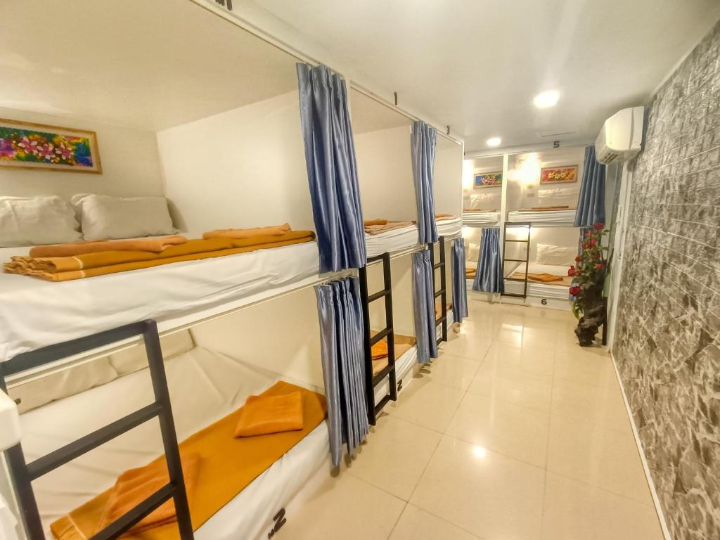 a group of bunk beds in a room at Jomtien Beach Hostel in Jomtien Beach