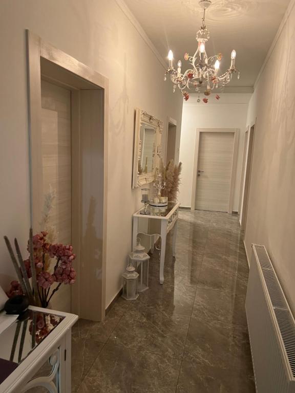 a hallway with a bathroom with a sink and a chandelier at Rooms Milena in Senj
