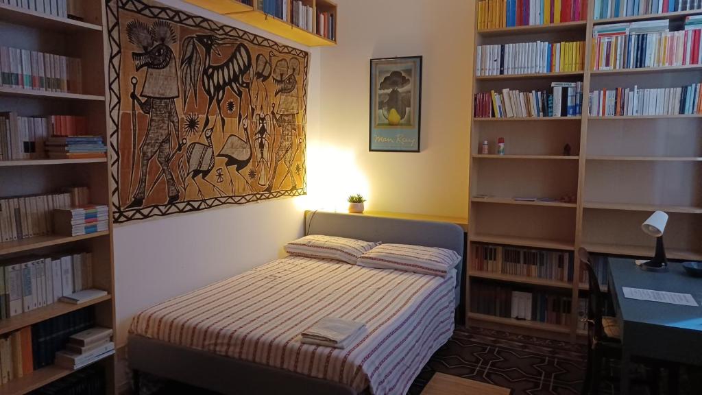 a bedroom with a bed in a room with bookshelves at Casa Braglia in Modena