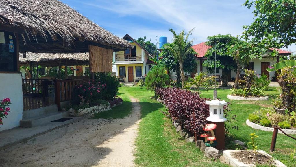 a house with a yard with a fire hydrant at Gardenview Homestay Siargao in General Luna