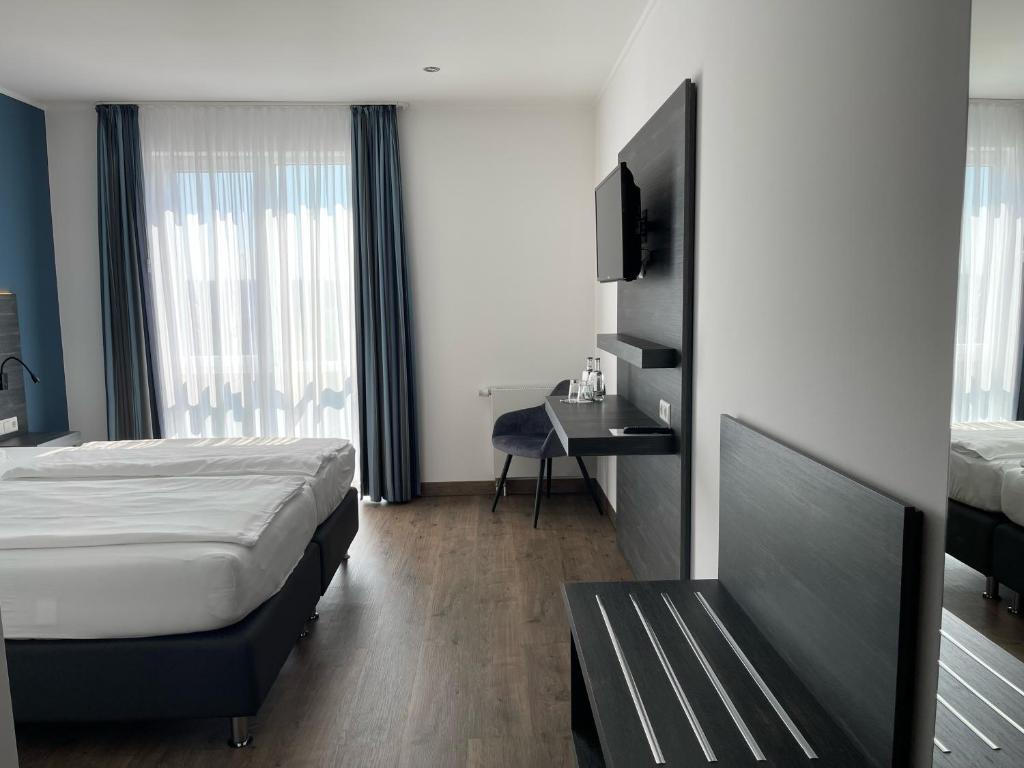 Postel nebo postele na pokoji v ubytování AiREA Hotel