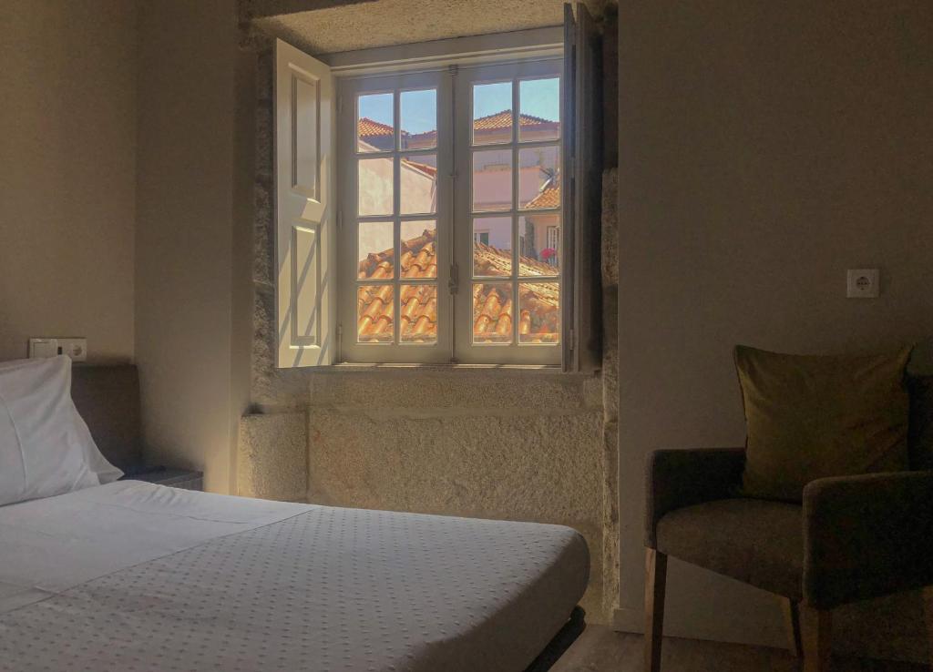 Postel nebo postele na pokoji v ubytování Rua Grande Hotel