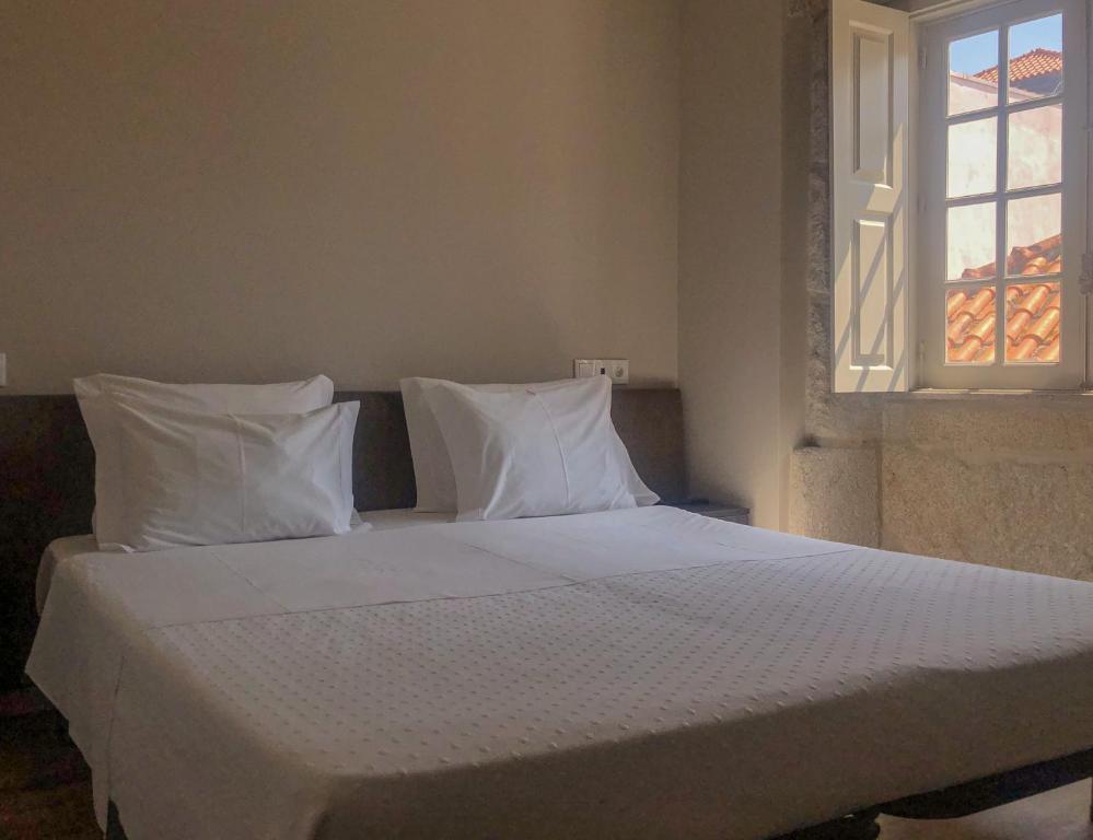 Postel nebo postele na pokoji v ubytování Rua Grande Hotel