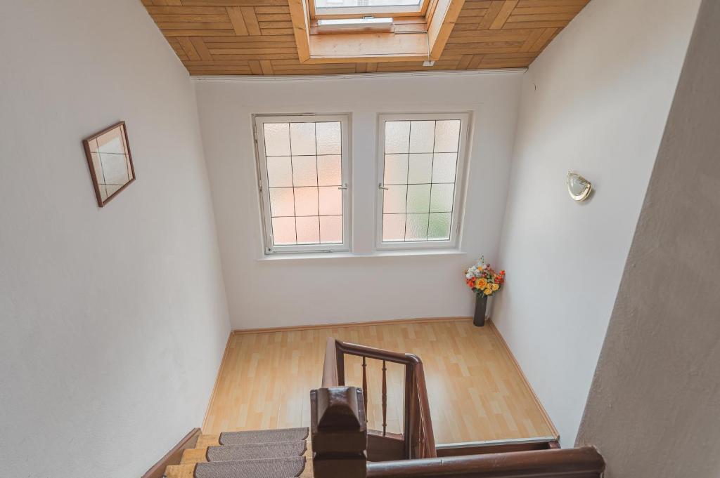 an attic room with a staircase and a window at Hotel am Schlossplatz in Hechingen