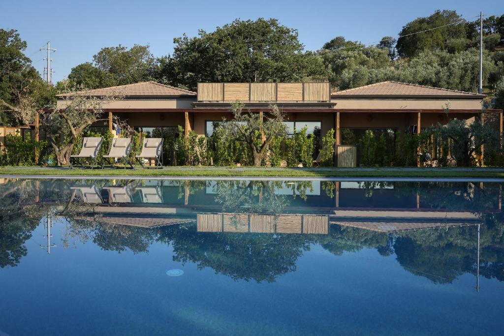 a house with a swimming pool in front of it at Hang Loose Cottage in Gizzeria