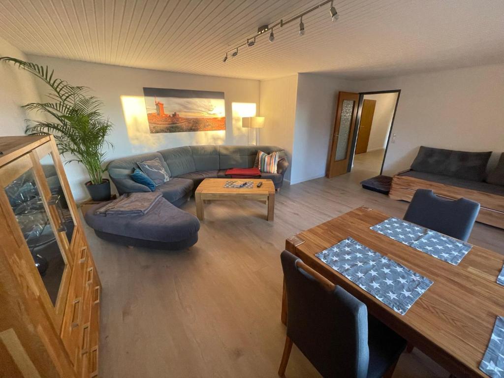 ein Wohnzimmer mit einem Sofa und einem Tisch in der Unterkunft Ferienwohnung Elfengast, FassSauna, Harzurlaub in bester Lage in Bad Harzburg