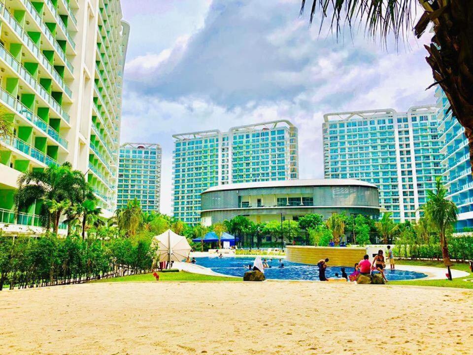 a resort with a pool and buildings and a beach at AZURE URBAN RESORT A3 near airport mall with Balcony wavepool in Manila