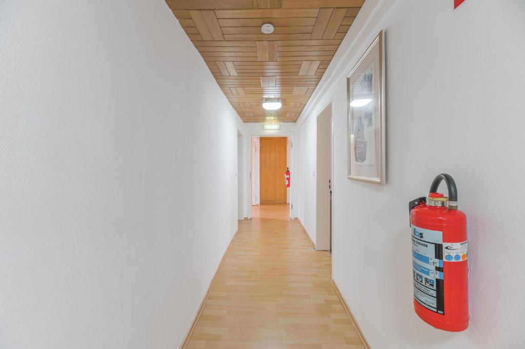 a hallway with a fire hydrant on the wall at Hotel am Schlossplatz in Hechingen