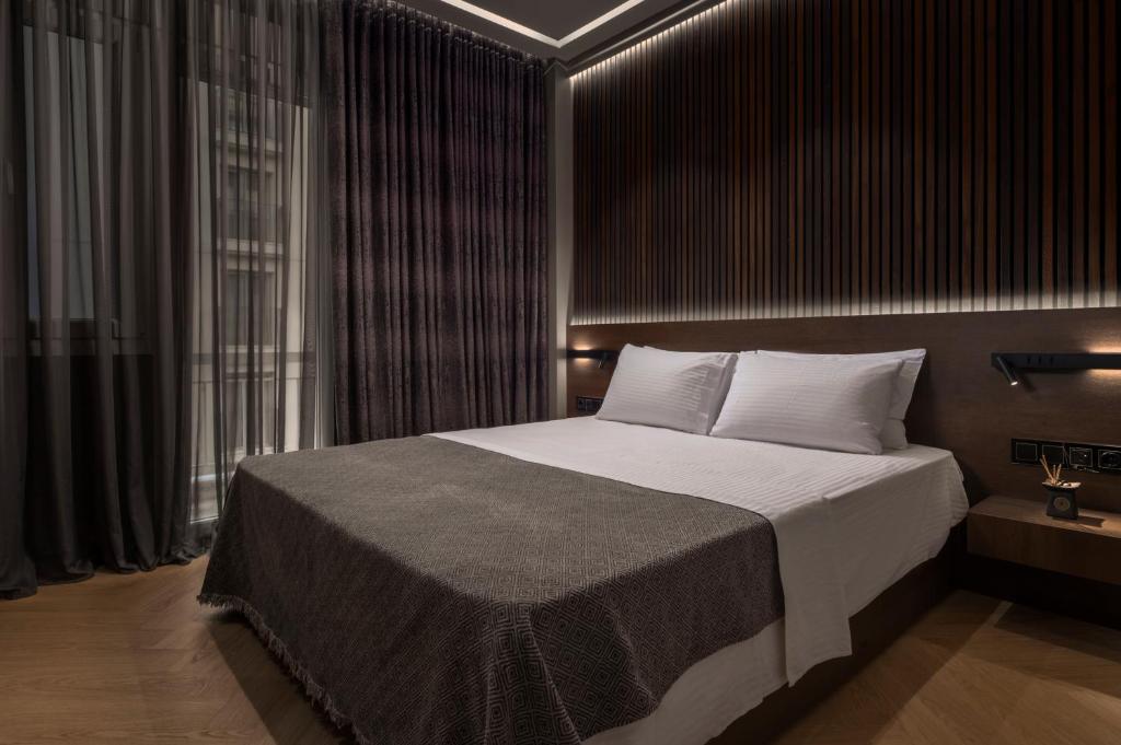Postel nebo postele na pokoji v ubytování OMEGA SUITE